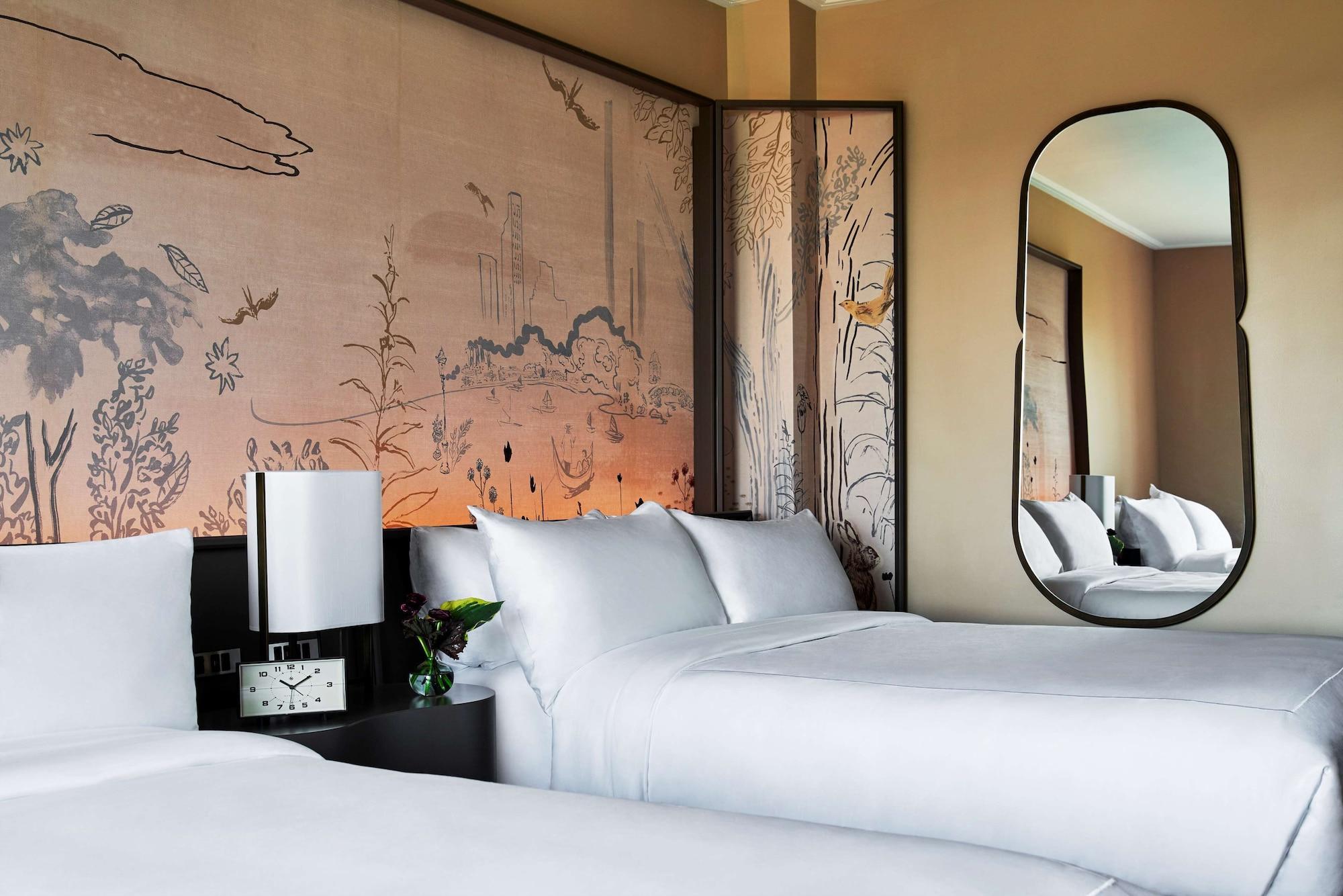 Hotel Park Lane New York Esterno foto The image shows a modern hotel room featuring two beds with white bedding. Behind the beds is a decorative wall with a soft, artistic design that includes landscapes and natural elements. There is a sleek, oval mirror on one side and a bedside table 